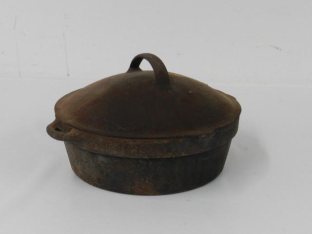 Cast Iron Dutch Oven: Has lid. Wear from use and minor rust. 10" wide