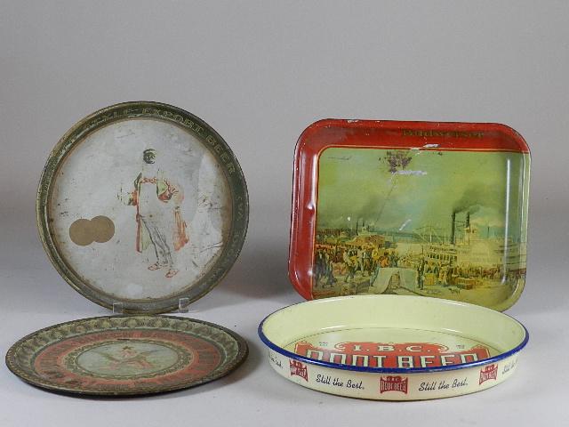 4 Beer Advertising Trays: Early Roanoke Brewing and Anheuser-Bush are damaged. IBC root beer has minor rust. Largest 13" wide