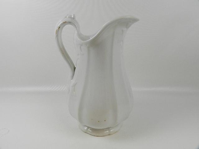 Large Ironstone Pitcher: Has leaf design on handle. Unmarked. Wear on handle and crazing to glaze. 13" tall