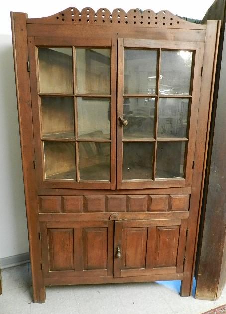 Walnut 12 Pane Corner Cupboard: wavy glass with 90 degree returns, railed mullions and original iron door hinges. Has some folk influence with 7 raised center panels across the waist and double panel raised lower doors. Has 2 latter