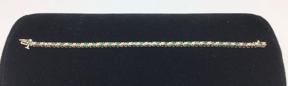 14k Yellow Gold Emerald and Diamond Bracelet: 1 1/2 ct emeralds . 0.25 ct diamonds. 7 inches. 8.60 grams total weight. Good condition. Display not included.