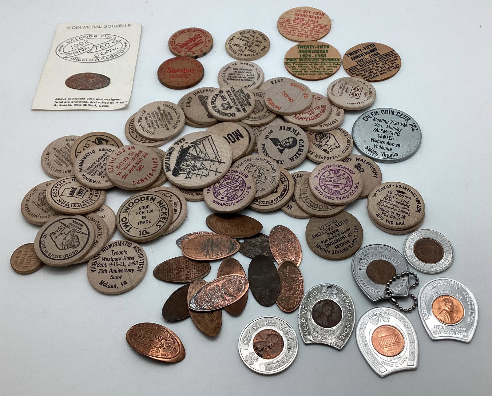 Exonumia Lot: Wooden nickels, elongated cents, and encased cents.
