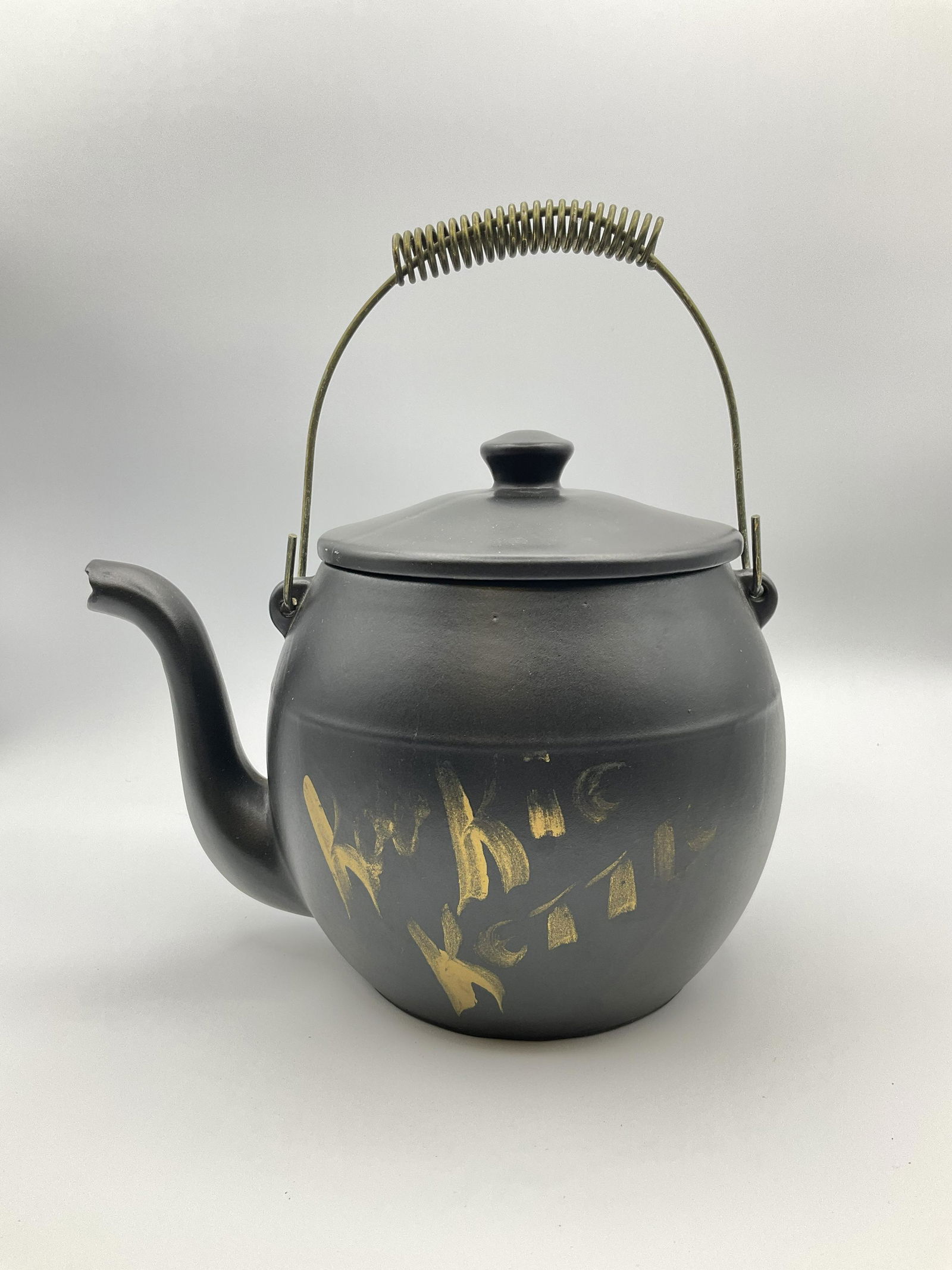 McCoy Kookie Kettle Cookie Jar: Made 1960-77. Some fading to gold lettering. Otherwise, good condition. 11 inches tall with wire handle.