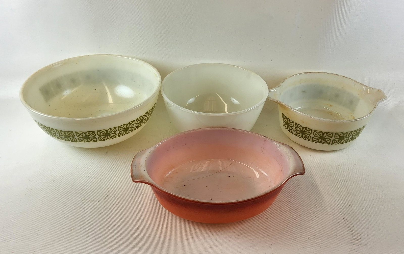 Four Vintage Pyrex Bowls: Considerable wear - largest is 10.25" in diameter