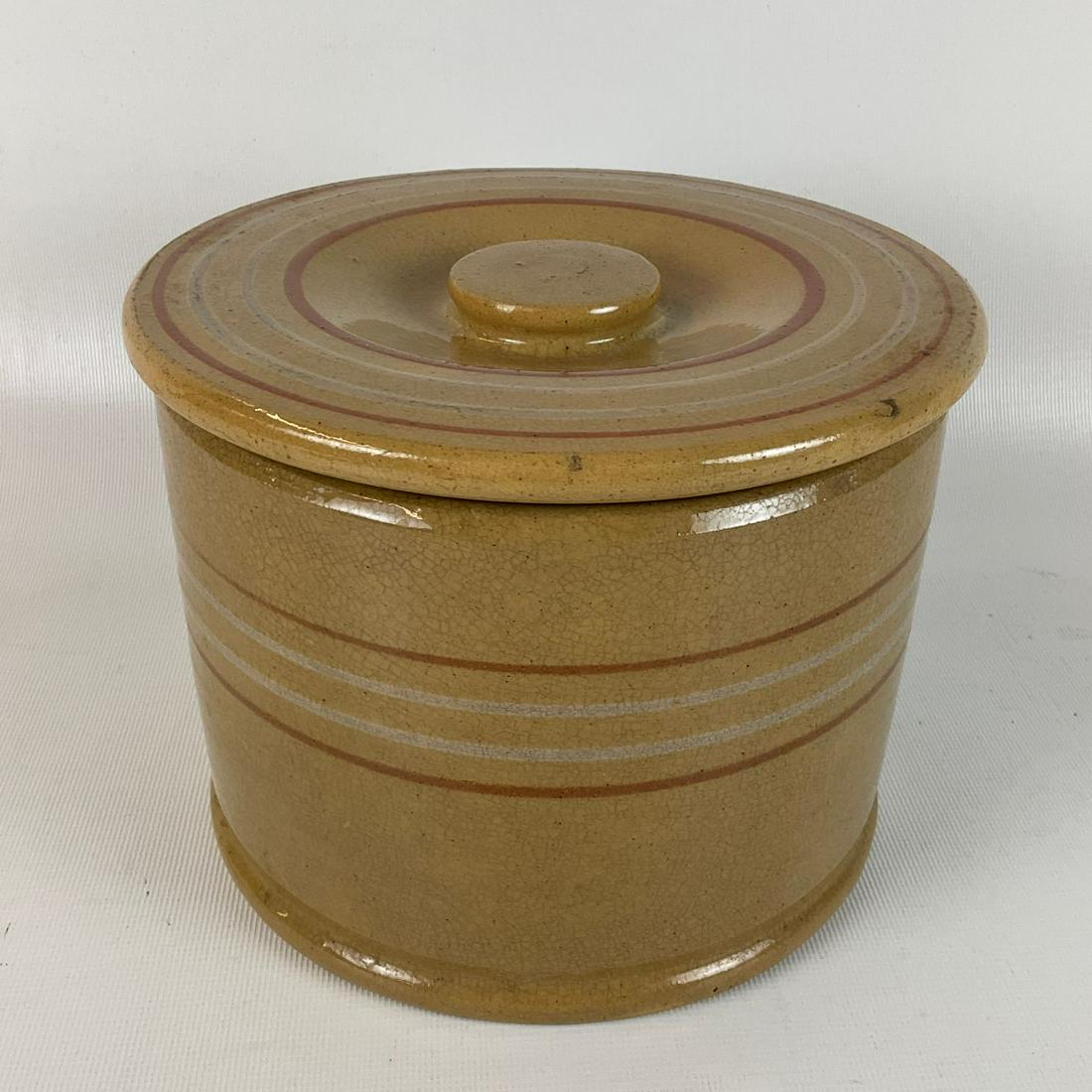 Rust & White Banded Yellow Ware Canister: Crazing, discoloration, minor chips. 7.25 inches wide x 5.5 inches tall.