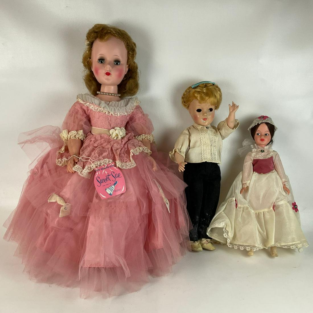 Vintage Dolls: American Character Dolls Sweet Sue in pink dress with paper tag. Articulated arms and legs, sleepy eyes. Horsman Mary Poppins doll with shoes and hat. Third doll is unidentified, eyes are disconnected