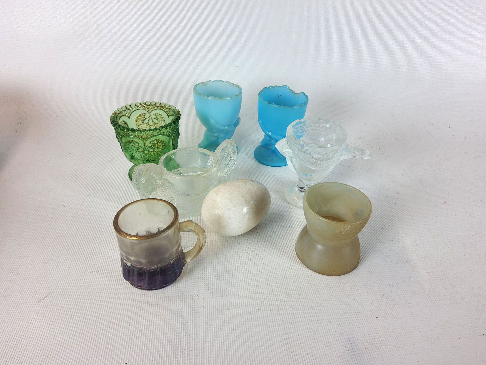 Group of Figural Glass Egg Cups Eggcups: General wear, some rough edges, chip on blue one - approximately 2.25" tall