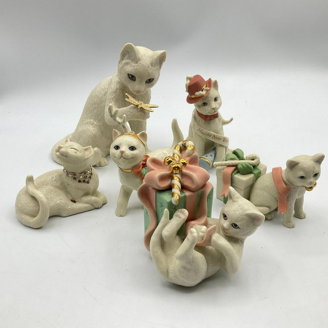 Lenox Porcelain Cat Figurines: Total of six but three are broken. Broken ones are Curious Encounters, Sweet Devotion, and one with antlers. Others are in good condition. Tallest is 5.25 ".