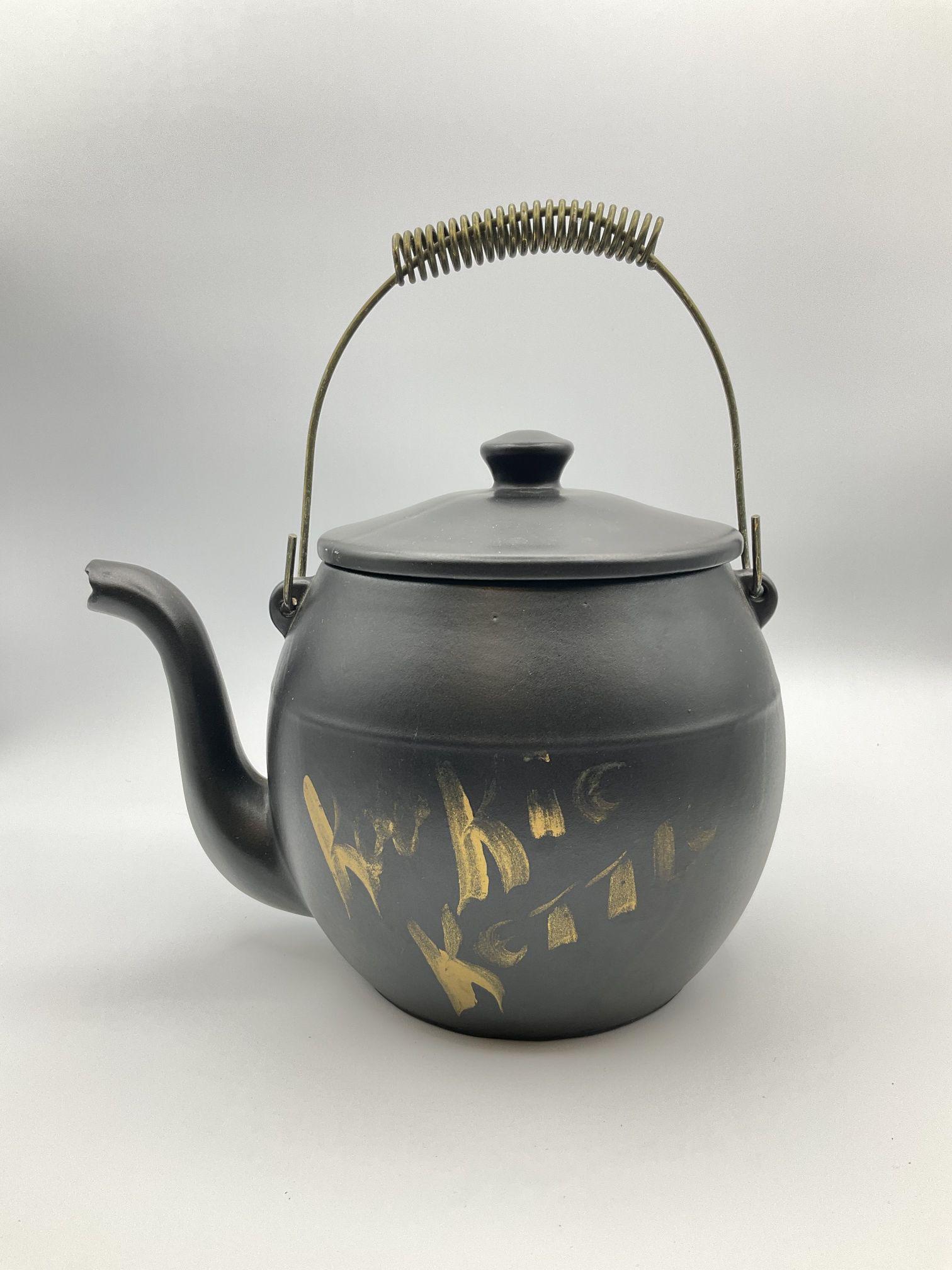 McCoy Kookie Kettle Cookie Jar: Made 1960-77. Some fading to gold lettering. Otherwise, good condition. 11 inches tall with wire handle.