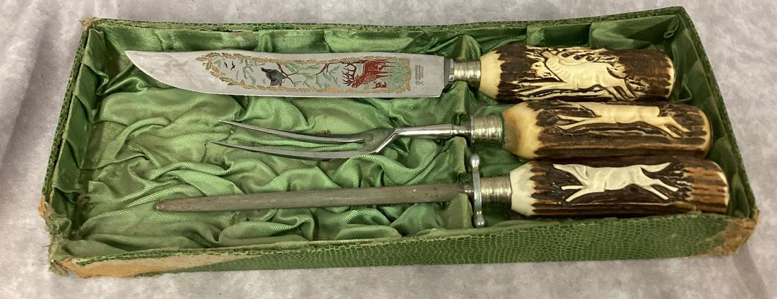 Kronenkrebs Solingen Carving Set with Carved Stag Handles: Each one has a different relief carved animal. Storage wear and minor wear to set. Housed in half the original box. Box is heavily damaged. Blade 7 1/2" long.