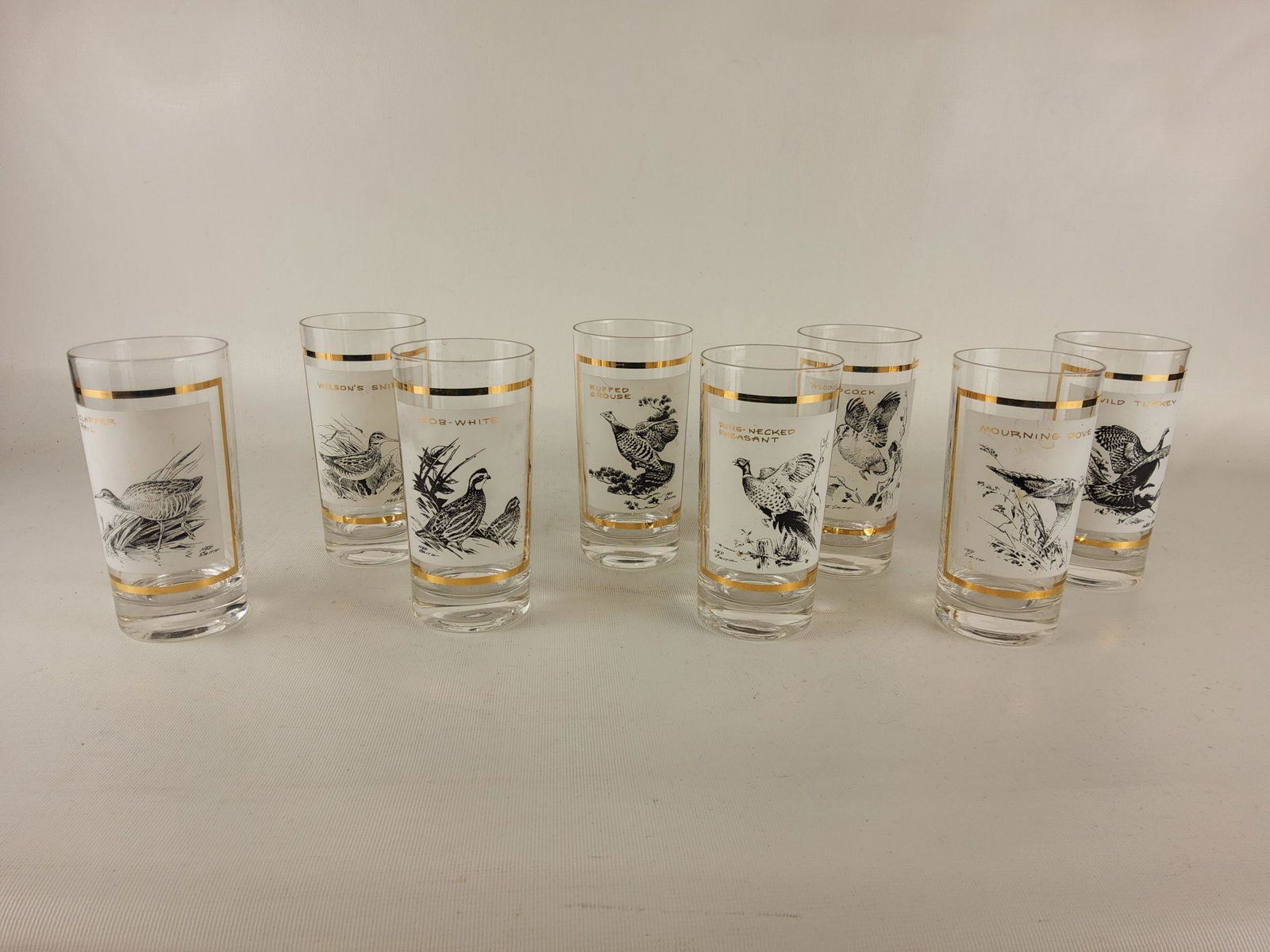 Eight Vintage Ned Smith Gold Rimmed Fowl Glasses Barware: Slight wear from previous use. No chips cracks or repairs noted.