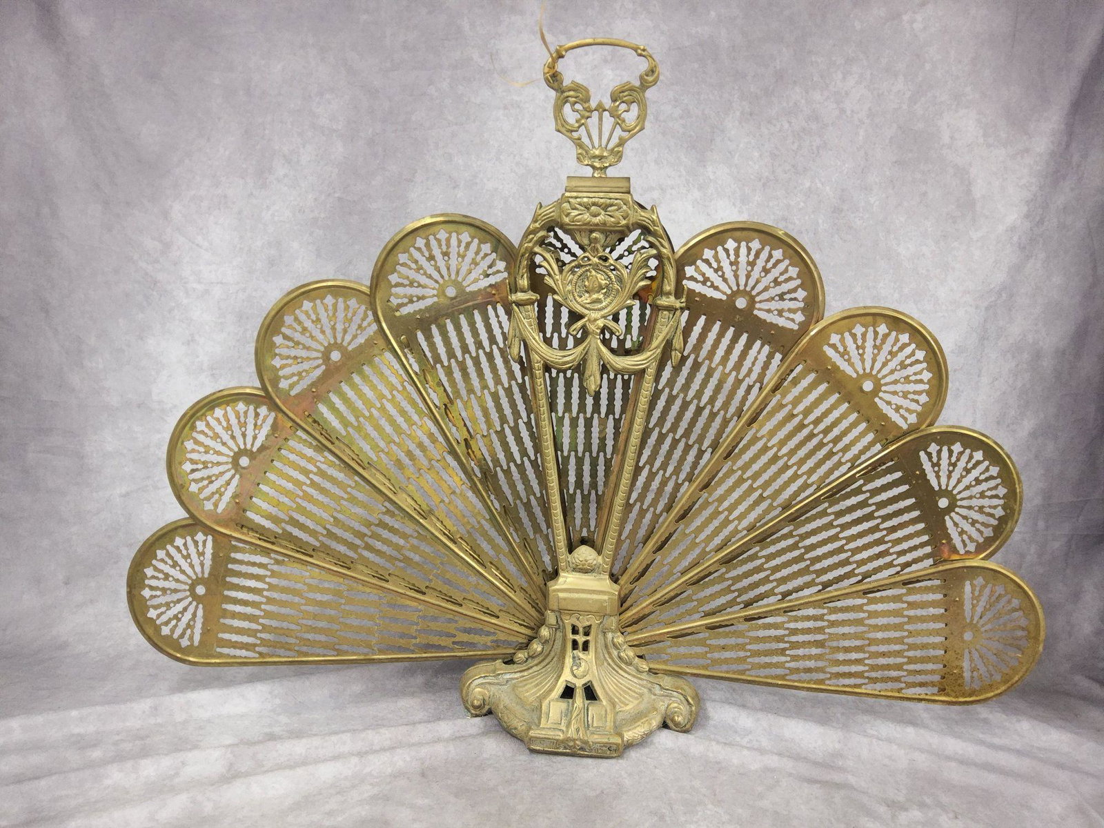 Early Ornate Brass Fireplace Screen: Slight wear from previous use. Measures 37 1/2 x 27 inches.