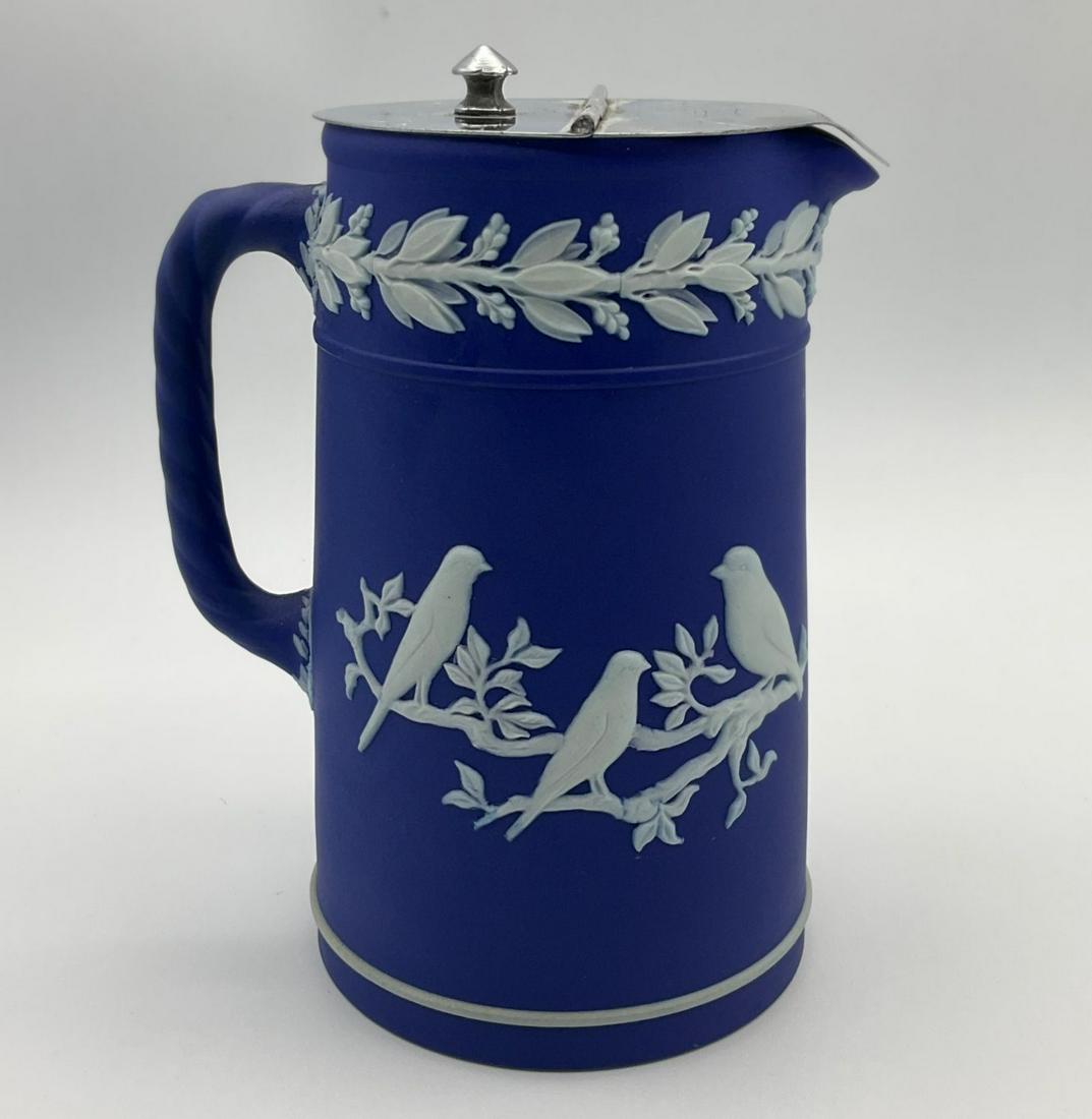 Wedgwood Blue Jasperware Syrup Jug: Caperns Birds pattern. Retail sticker from Wedgwood specialists Seal Simons of Philadelphia. Slight tarnishing to hinge on lid, otherwise good condition. 6.25 inches tall x 3.75 inches at the base
