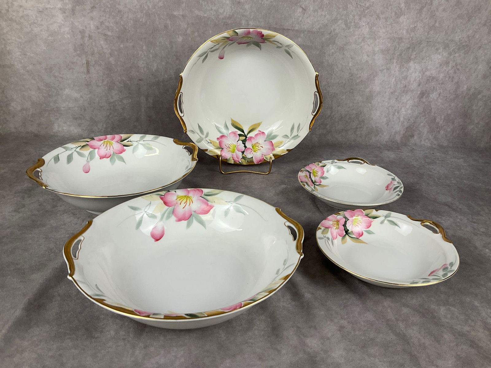 Noritake Azalea Bowls: Hand painted. Red and green back stamps. Three 10 inch bowls. Two 6.25 inch wide bowls. Wear to gilt on edges.