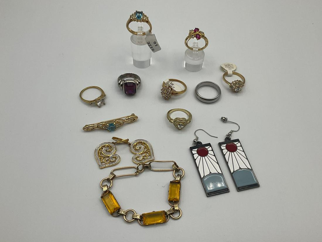 Fashion Jewelry: Gold plated rings, several size 10-11, some with CZ, brooch, bracelet, etc. Overall good condition.