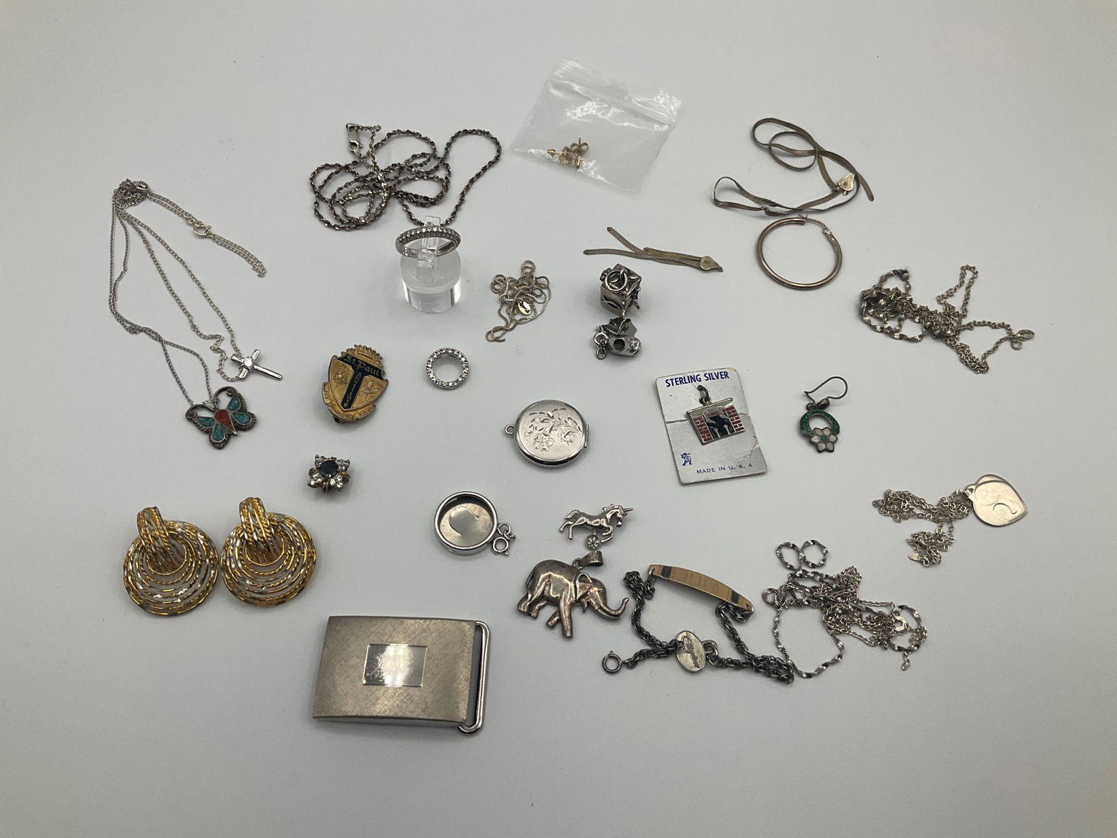 Sterling Silver Group: Many are broken scrap pieces. Some charms and earrings are in good condition. Includes a very tiny set of 14k gold stud earrings. Total weight of silver excluding items with stones is 2.65 ozt.