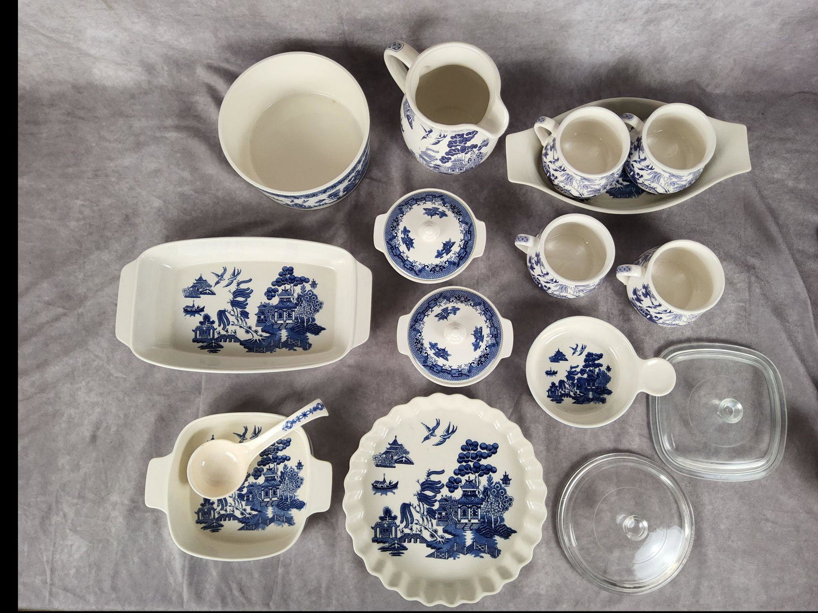 Heritage Mint LTD Blue Willow Group: All Heritage Mint LTD Blue Willow. Small chip in the ladle, everything else in good condition. Includes multiple different bowls and a pitcher. Also includes two clear glass lids. Largest piece is 13 