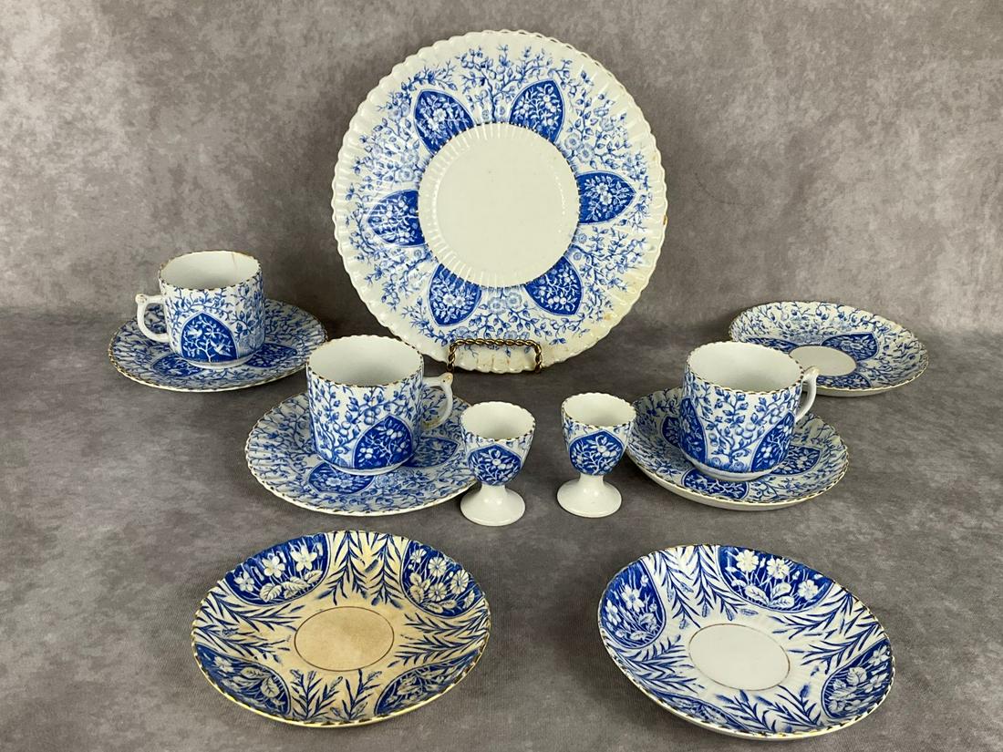 1880's English Blue & White China: Pattern with birds, wild roses, and apple trees. Pieces marked with late Victorian registry mark. Hairline cracks to tea cups and egg cups. Two saucers of a different pattern, marked B and B. Some cra