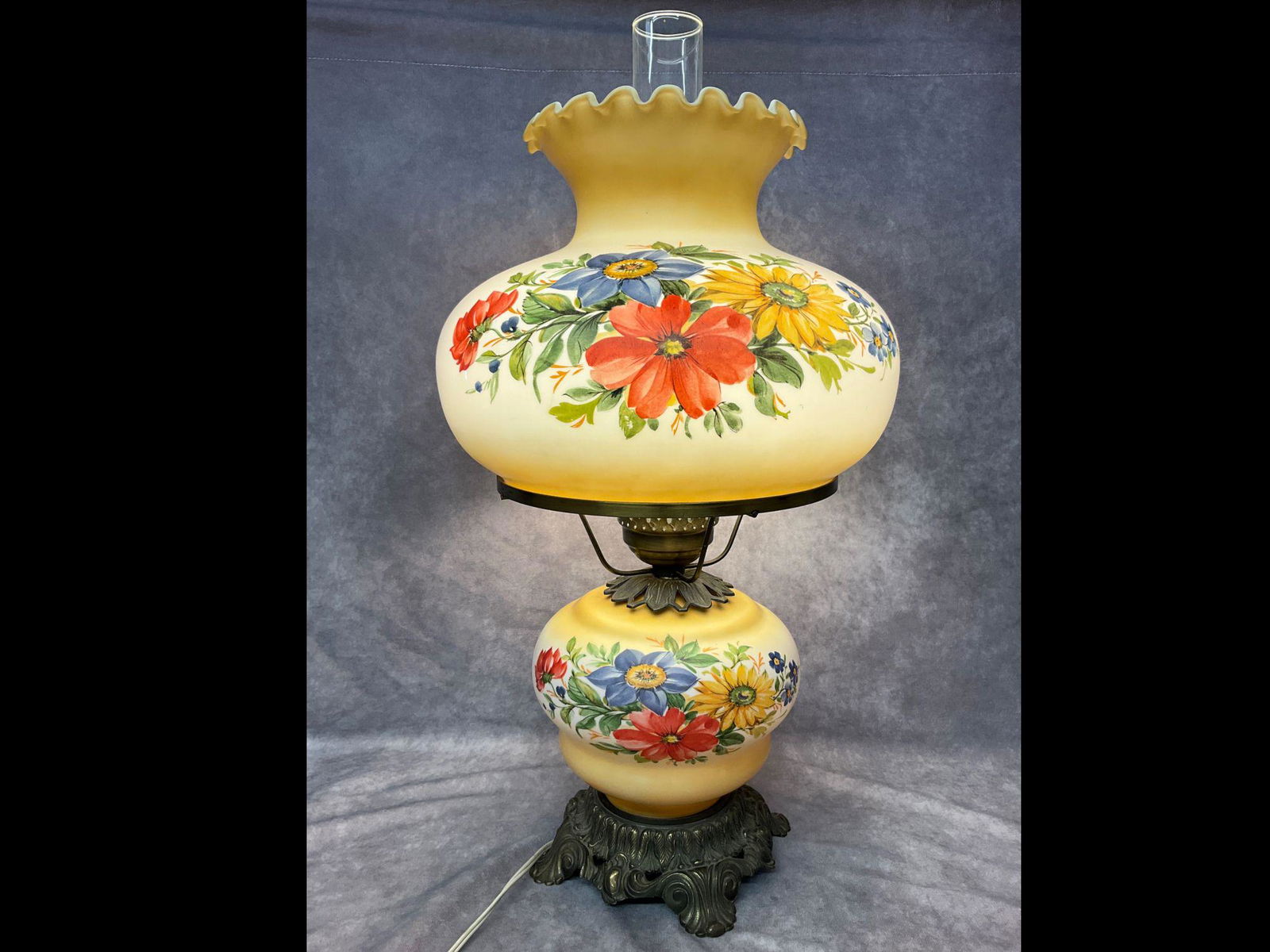 1970's Gone with the Wind Lamp: Base marked 1971 L and LWMC. Decal decoration. Top and base both light. Good condition with minor wear. 24 inches tall. Shade is 13 inches at the widest.