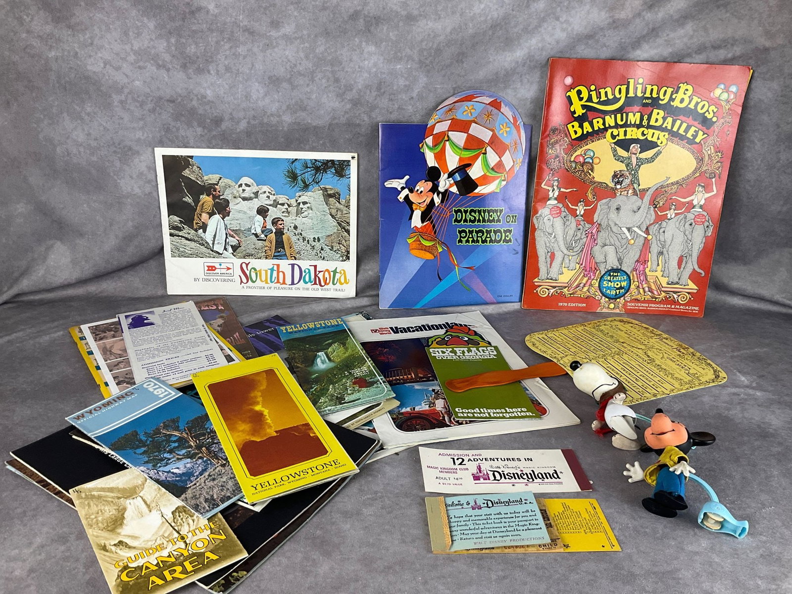 Disney & Travel Collectibles: Disney on Parade program, Mickey and Snoopy Mattel Skediddlers, vintage Yellowstone brochures, Disneyland ticket stub, Ringling Brothers 1970 program, and more. Paper is in good condition-some loose p