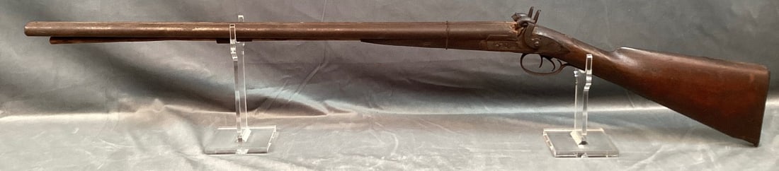 Stevens Side by Side Percussion Shotgun in 10GA: Serial# None. Does not function. All brown gun with rust throughout. Forearm held on with wire. Stock is fair with several areas of loss. One ramrod ring is detached but present. Damascus barrels 32"O
