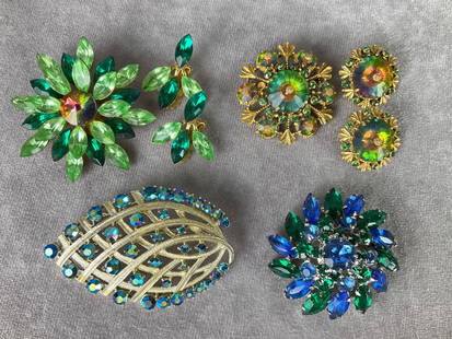 Sparkling Rhinestone Costume Jewelry: Large leaf brooch with blue aurora borealis jewels is signed Coro, 3 inches wide. Other unsigned. All earrings are clip. Goldtone and green brooch is missing one stone. Good condition otherwise.