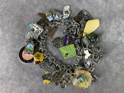 Sterling Silver Travel Charm Bracelet: Charms for California, Tahiti, Arkansas, New Zealand, New Mexico, Texas, jade Buddha, cuckoo clock, steins, New Orleans, Ireland, and many more. Many, but not all, are sterling. Good condition.