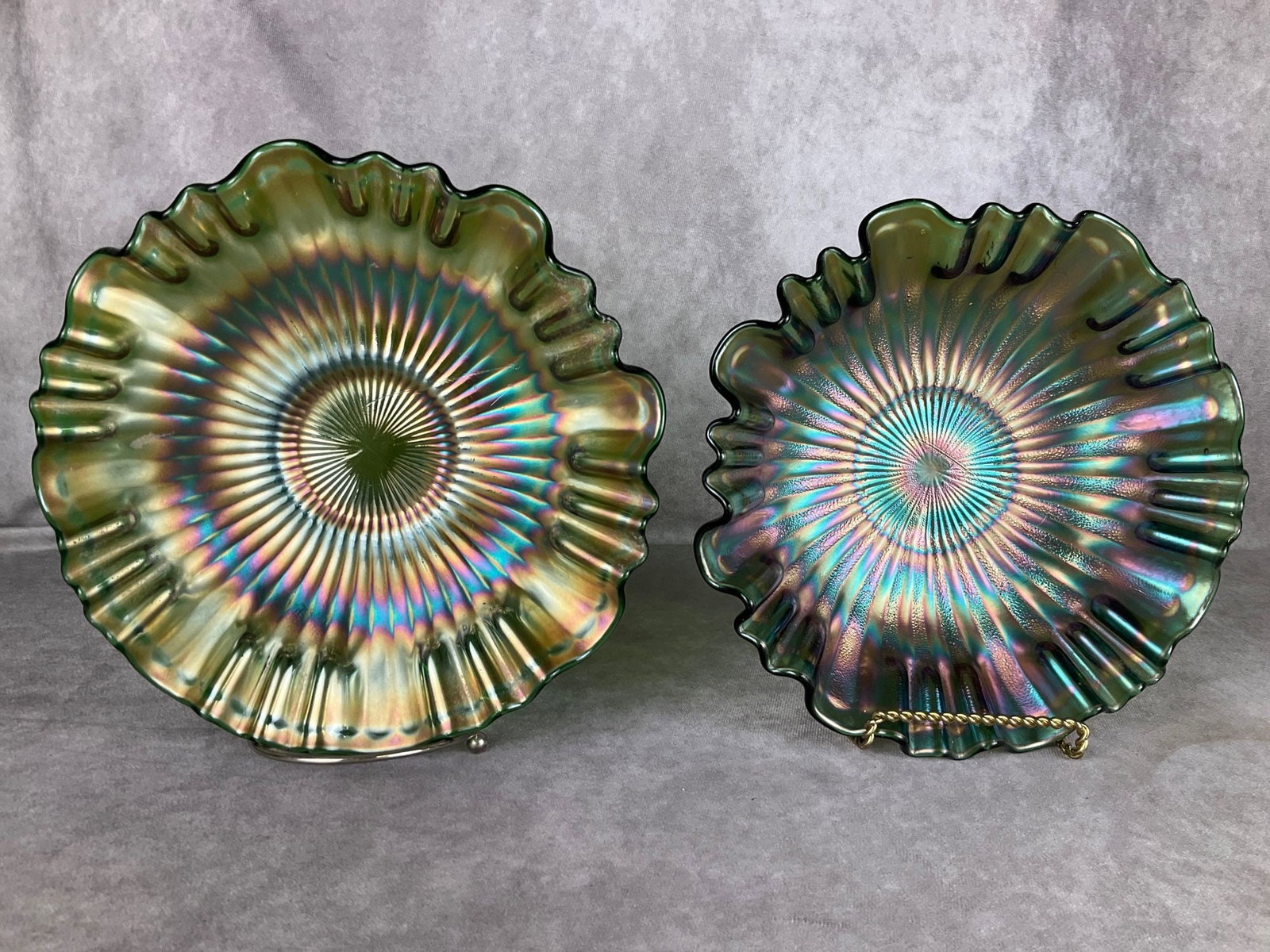 Fenton Carnival Glass Bowls: Smooth and stippled ray. Ruffled edges. Some string flaws original to pieces. Both in green. Good condition. Largest is 9 inches wide x 2.25 inches tall. Stands not included.