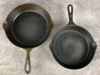 Two Griswold Cast Iron Skillets: One no. 6 635-G and one no. 7 Erie 701-E skillets, both marked Griswold. 8 and 7.5 inch bases. Show signs of general use.