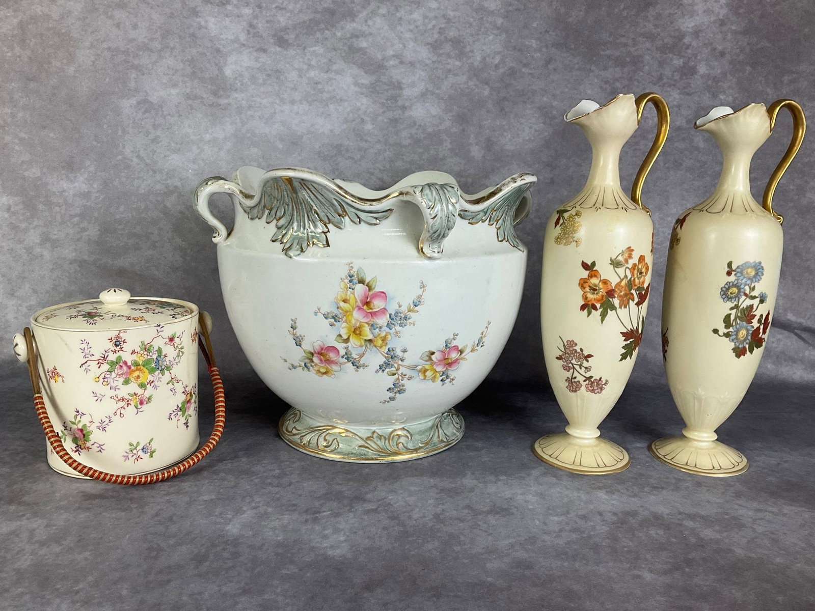Floral Ceramic Collectibles: 10 inch jardiniere with with gold painted and floral spray decoration that has been repaired and bears a crack on rim, pair of 12.75 inch ewers with impressed 477 and III marks on bottoms in good cond