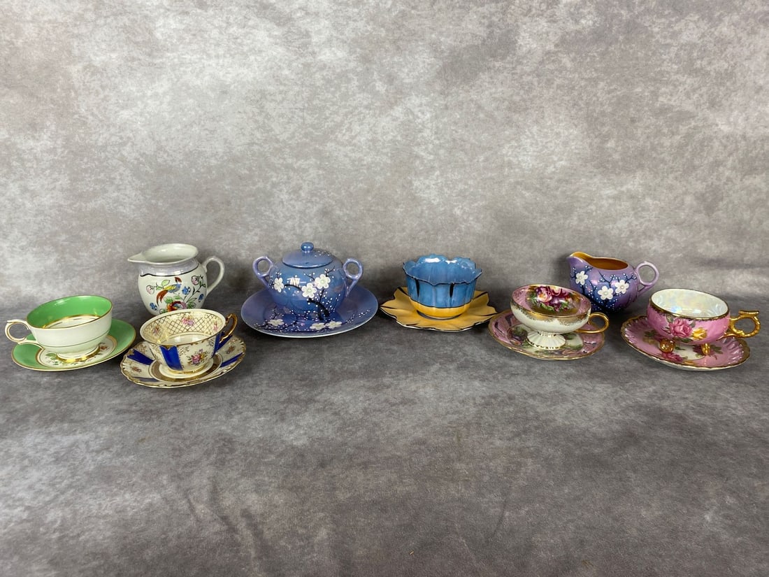 Cups and Saucers: Lustreware Japanese cherry blossom teapot with matching plate and saucer, other pieces of lustreware by Royal Halsey and Goldcastle. Others by Winterling and Clarence. Winterling saucer is chipped, fe