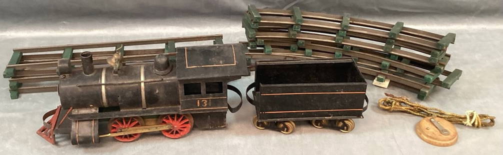 Rare Carlisle and Finch Electric Steam Engine and Tender Circa 1910: Painted tin and wood locomotive number 131 and N and M embossed tin tender with 12 pieces of original track. Wear from use and some areas of rust. Engine is 12" l x 5 1/2" h