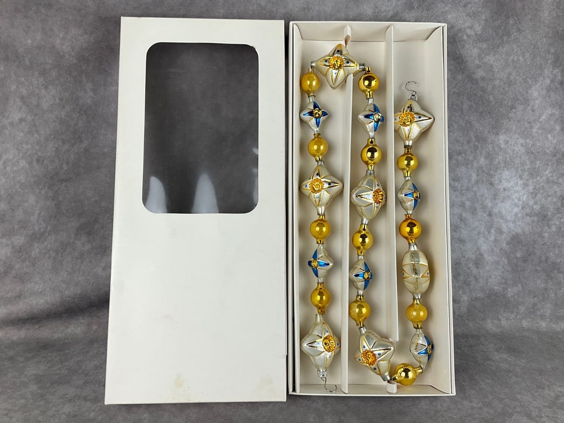 Christopher Radko White Stars Glass Garland: 38 inches. Good condition with some wear to original box. Made in Germany.