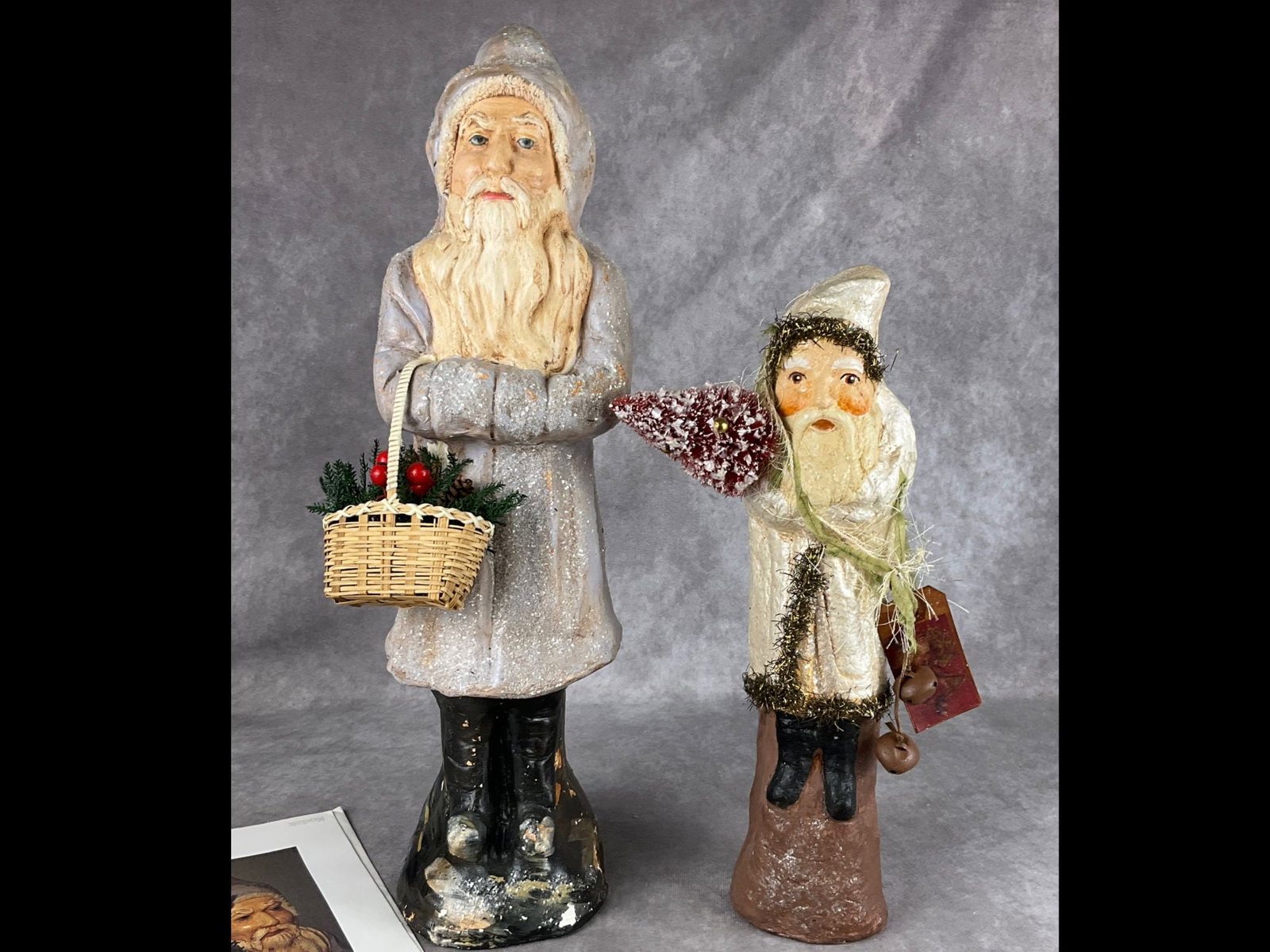 Mica Decorated Belsnickle Figures: Tallest with basket was made in 2005 at The Little Falls School of Decorative Arts of New York. He has had some paint loss and touch ups. 16.5 inches tall. Shorter with red tree was created by Cathy W