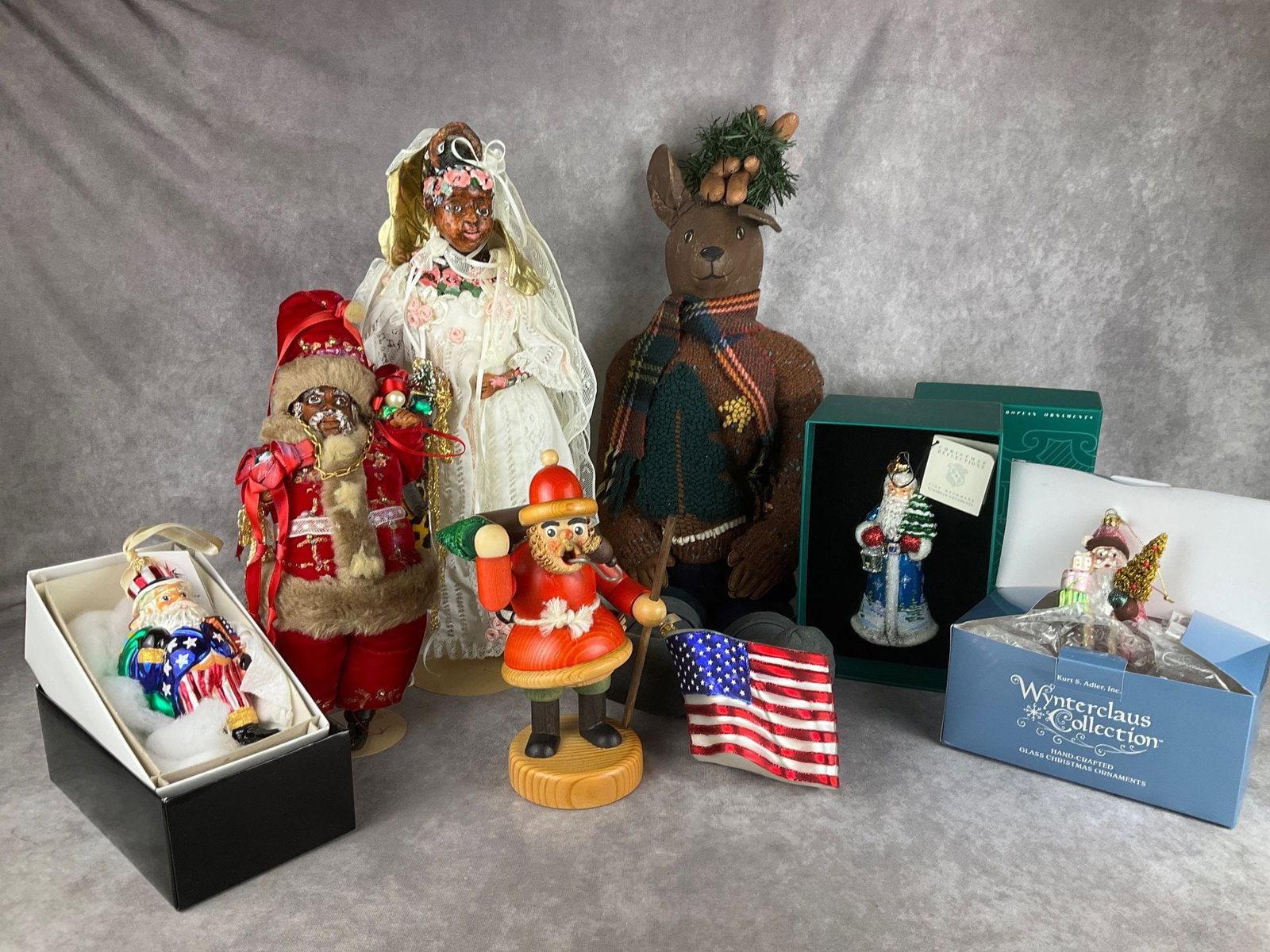 Christmas Collection: Glass Santa ornaments by Christopher Radko, Kurt S. Adler, and Reed and Barton, leather and wool large reindeer in sweater and boots, hand crafted Black Santa and angel, all in good condition. With a 