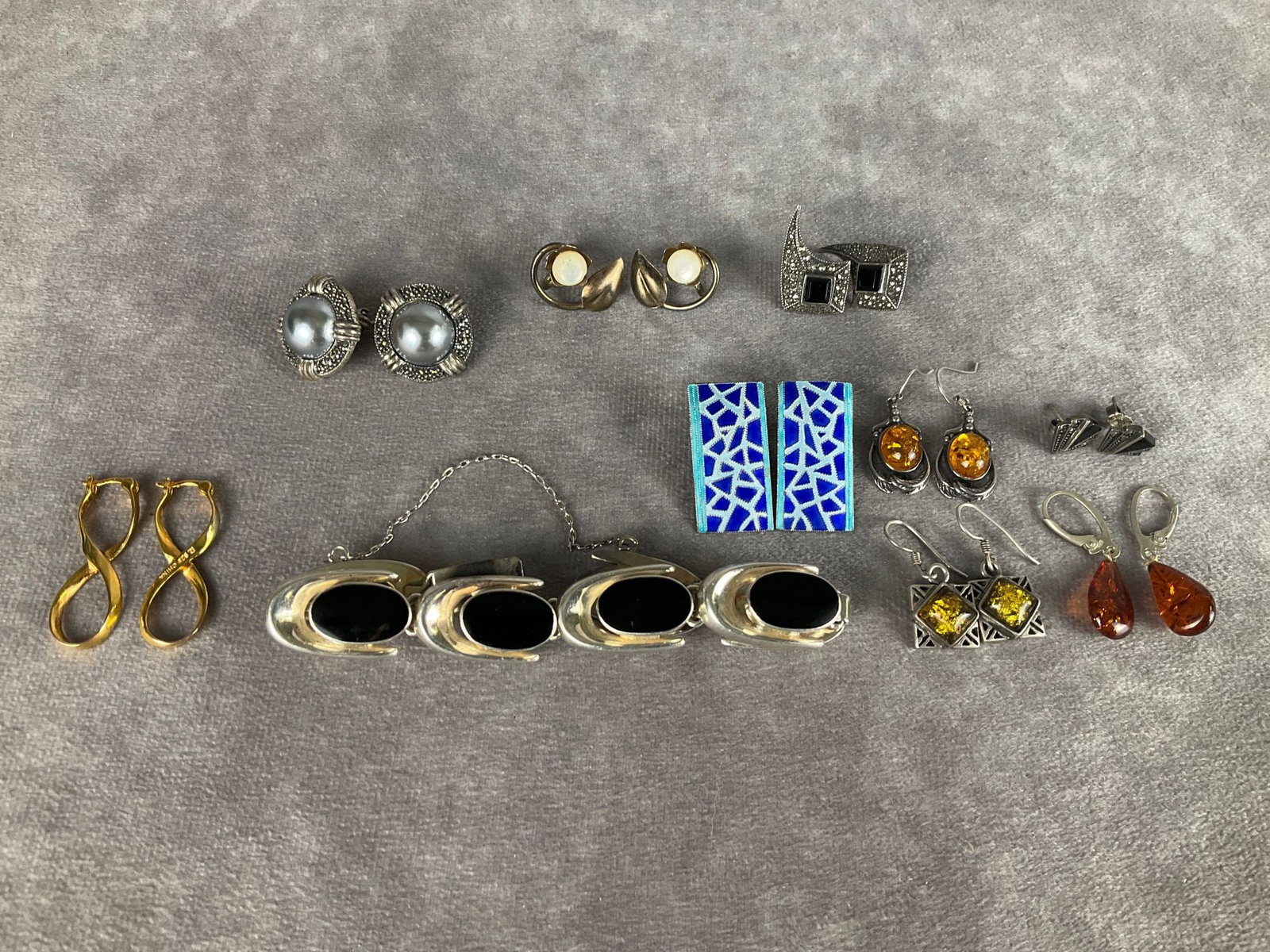 Sterling Earrings and Bracelet: Modern design bracelet with black stones and nine pair of earrings. Post, hook, clip, and screw back. Pieces are marked silver, 925, and sterling. Good condition.