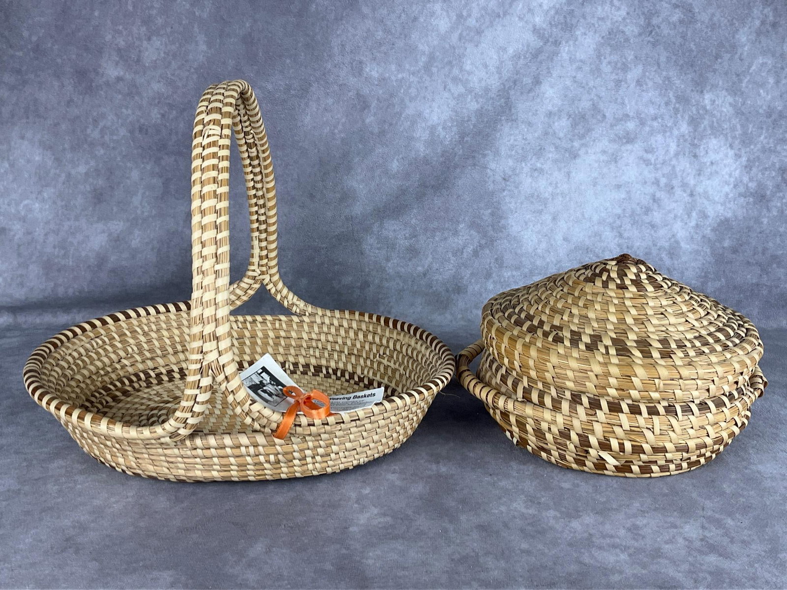 South Carolina Sweetgrass Baskets: Basket with single handle is tagged for Henrietta Snype of Mt. Pleasant, SC. Basket is made from sweetgrass, bulrush, palmetto, and pine needles. 11.5 inches wide x 9 inches tall. Good condition. Seco