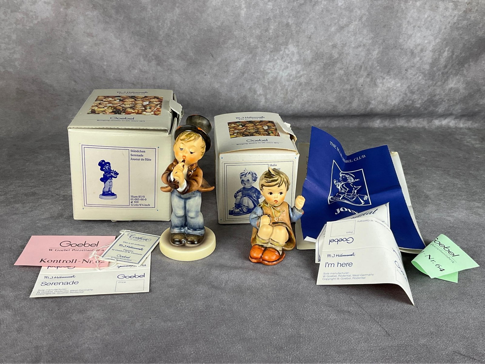 Hummel Figurines: Both with boxes and papers. Serenade, and Hallo I'm Here. Serenade is 4.75 inches tall. Good condition with wear to packaging.