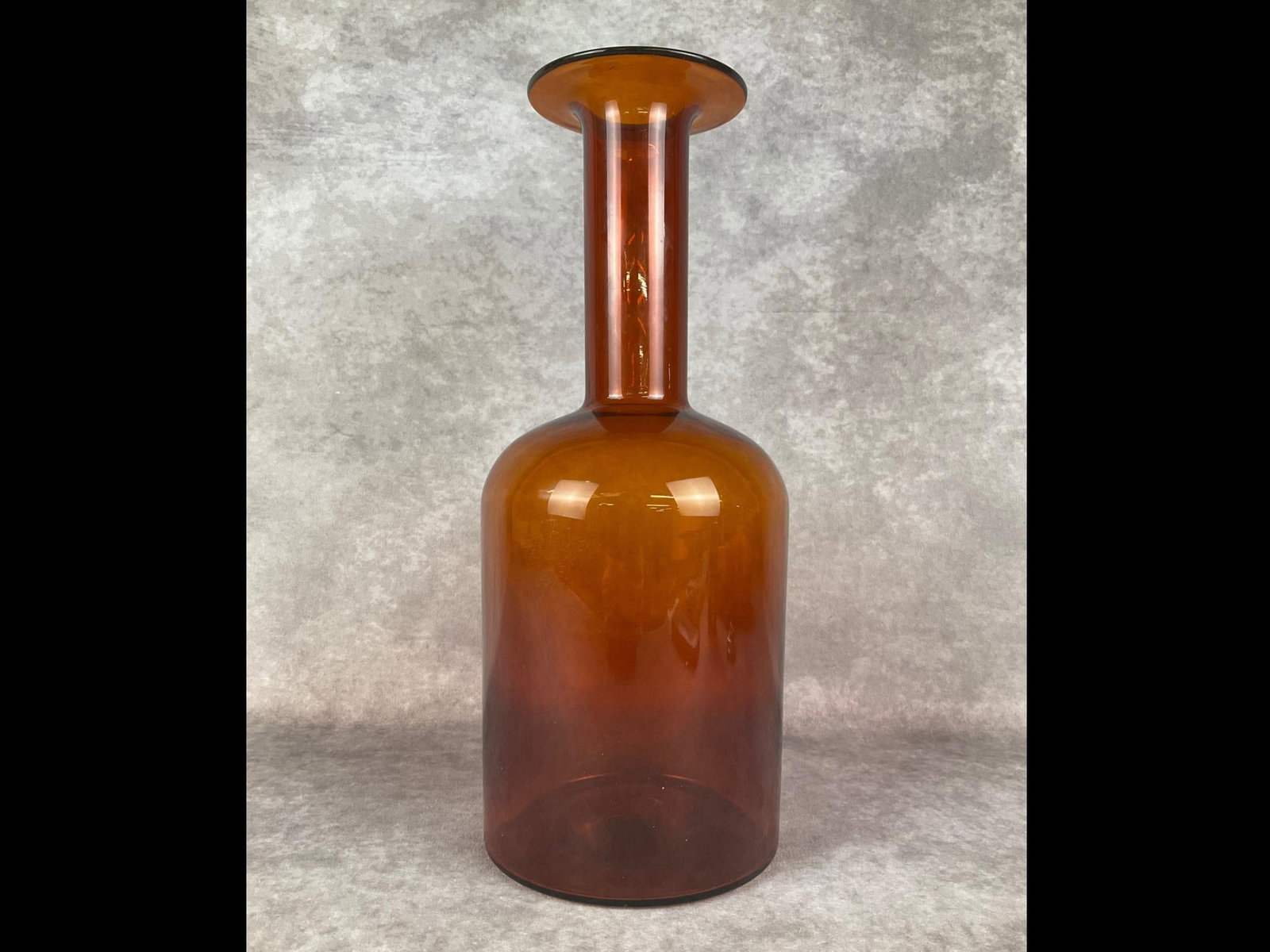 Mid Century Danish Glass Vase: Unmarked but attributed to Otto Brauer for Kastrup Holmegaard in Denmark from the 1960s. Deep caramel amber glass decanter style vase with height of 14.75 inches. Good condition.