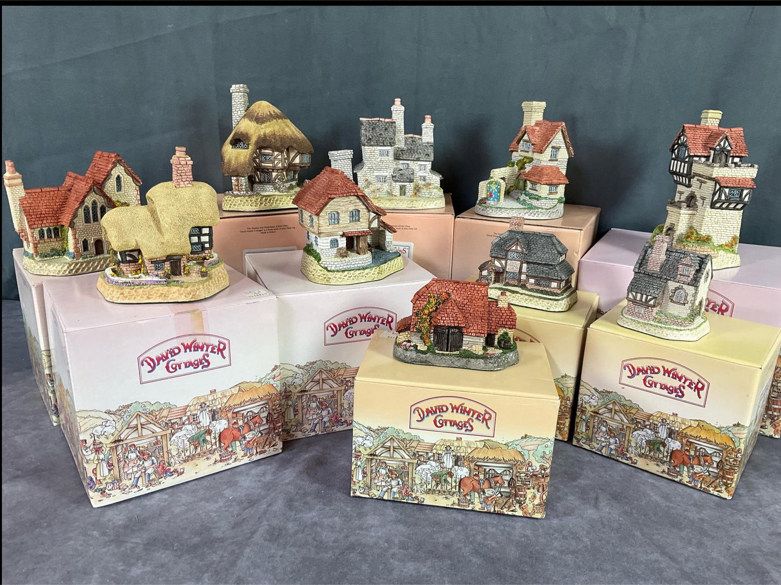 David Winter British Traditions: Group of 10. Includes Blossom Cottage, Knight's Castle, Staffordshire Vicarage, St. Anne's Well, Pudding Cottage, Stonecutters Cottage, Harvest Barn, The Bull and Bush, and Guy Fawkes. Knight's Castle