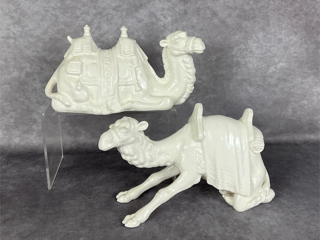 Two Goebel Camels: Both in white over-glaze. Lying 46 821-11 with height of 4.5 inches, and Kneeling 46 830-12 with height of 5.5 inches. Good condition.