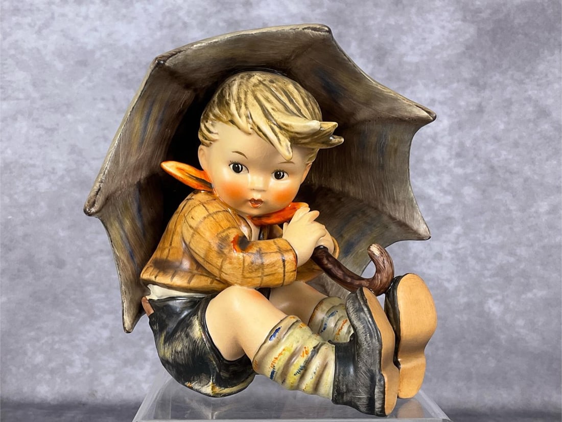 Umbrella Boy: Hum 152/0 A. TMK 4 with incised 1957 copyright date. Height of 4.75 inches. Mild to moderate crazing to glaze, overall good condition.