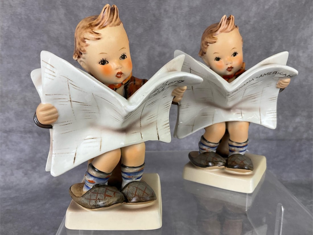 Two Latest News Hummels: Hum 184. TMK 2. One newspaper is titled Heidelberg Nachrichten and the other is Panama - American. Both 9 5 inches tall and in good condition.