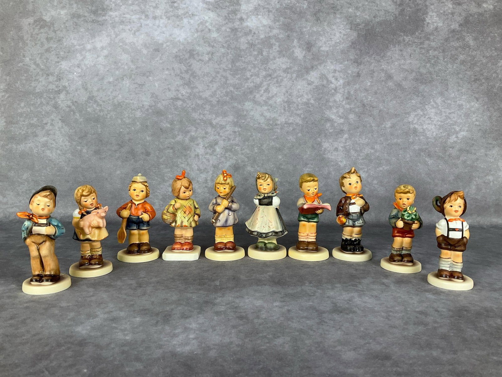 Ten Hummel Club Exclusive Figurines: Lucky Fellow Hum 560 TMK 7, Pigtails Hum 2052 TMK 7, First Mate Hum 2148/B, I Brought You a Gift Hum 479 TMK 8, Sharpest Student Hum 2087/A TMK 8, Honor Student Hum 2087/B, All Smiles Hum 498 Limited 