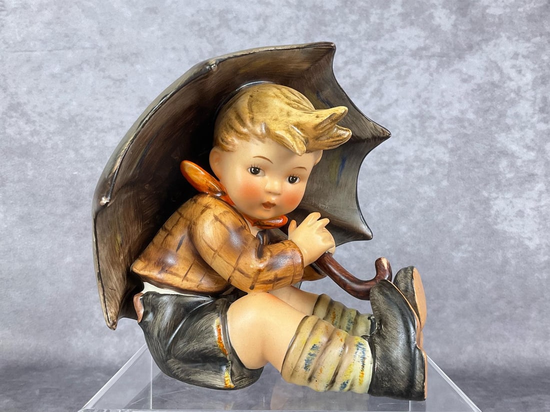 Umbrella Boy TMK 2: Hum 152/0/A. Stamped High Bee in incised circle with partial 1957 copyright stamp. 4.75 inches. Good condition.