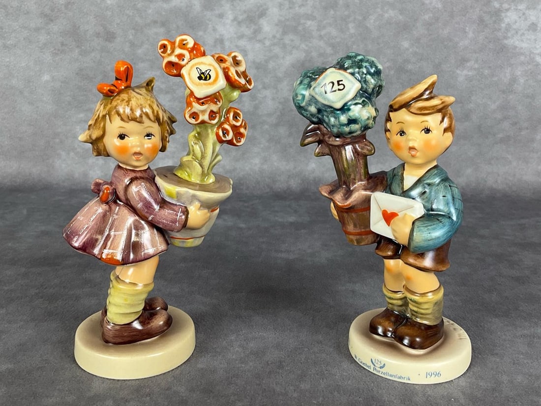 Special Edition & Anniversary Hummels: Good News Hum 539 S.E. 125th Anniversary issue, and Best Wishes Hum 540 Special Event 1997 with flying bee decal applied amongst the flowers. Both TMK 7. Tallest 4.75 inches. Good condition. Include o
