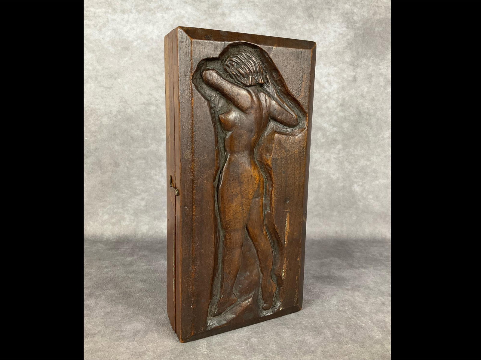 Carved Nude Woman Wooden Flask Bottle Holder: Hinged wooden box that opens to a hollowed out area that would conceal a flask bottle. Outside is a carved side profile of a nude woman. Note from the seller says that this came with a collection of p