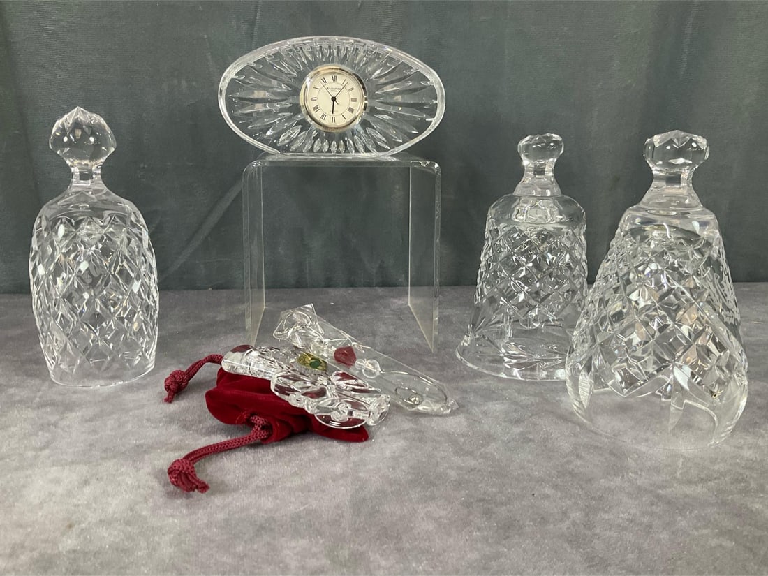 Waterford Crystal: 1987, 1988 and 1989 Christmas bells in good condition.1988 does not have clapper. Non working desk clock with cracked face. Christmas ornament with hanger and box. Appears to have not been used. Stand