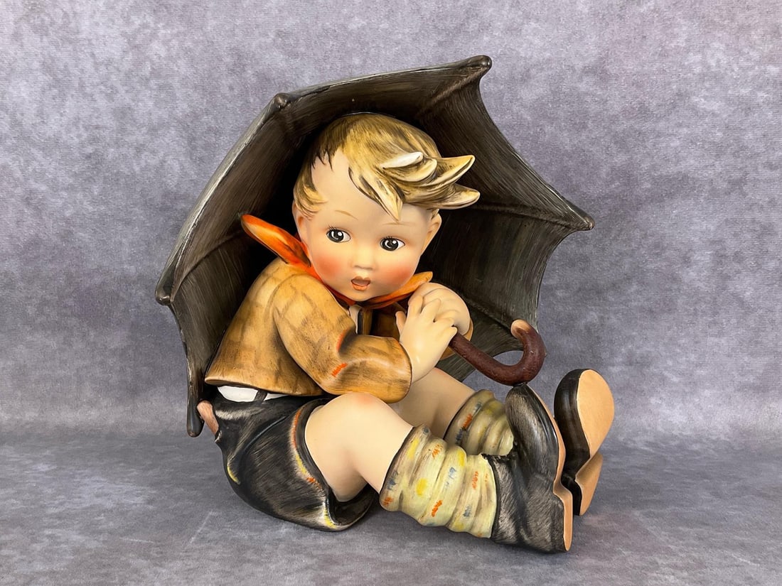 Umbrella Boy TMK 2: Hum 152 A with stamped bee mark. Height of 7.5 inches. Several light scratches on back of umbrella and typical paint smudging on bottoms of boots, overall good condition.