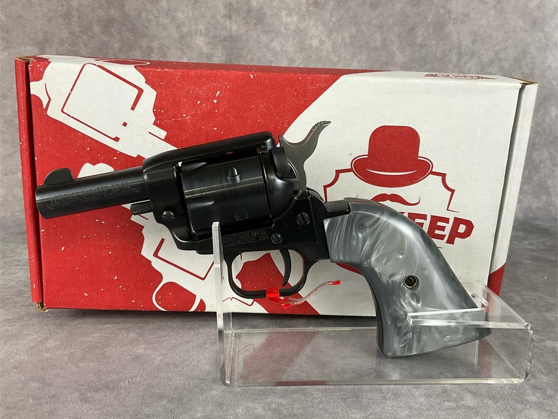 Heritage Barkeep Single Action Revolver: .22 cal. 2 inch barrel. Like new in factory box. Gray pearl grips. Serial 1 BH613376.